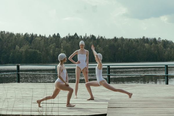 Group of women practicing yoga outdoors peacefully.