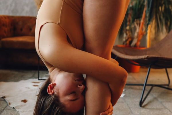 Woman holding a challenging yoga balance pose.