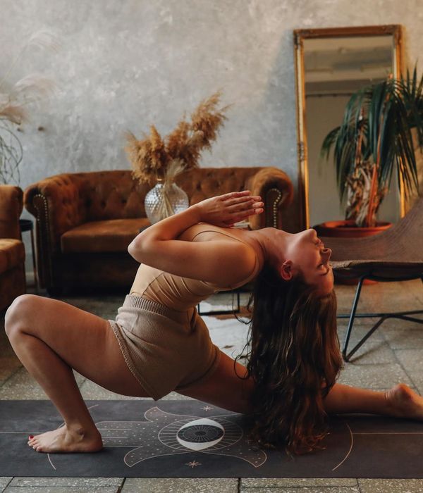 Woman meditating in a peaceful yoga pose, soft lighting.